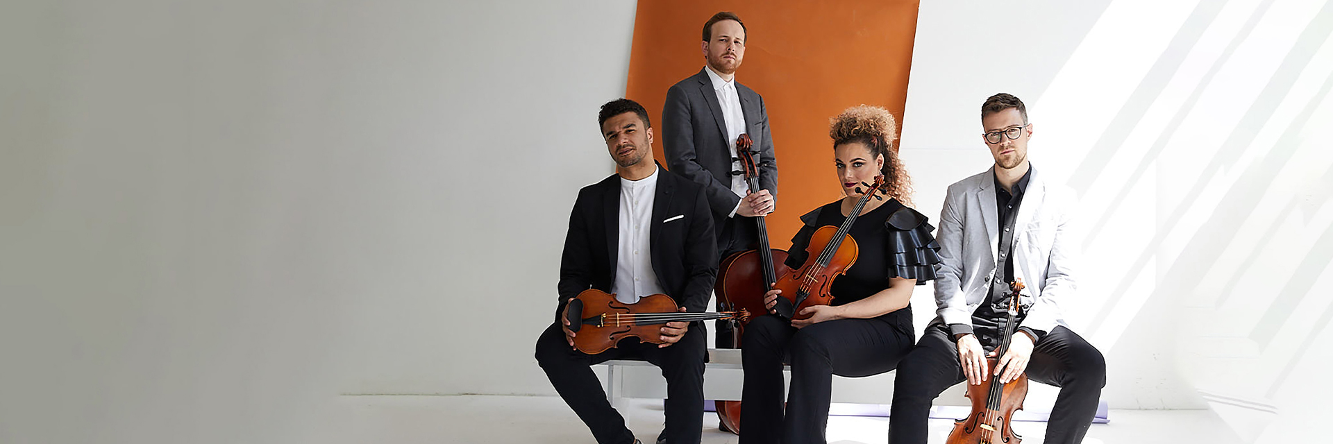 four musicians of PUBLIQuartet sitting together